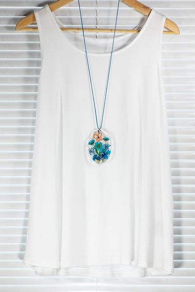 OVAL TURQUOISE PENDANT WITH AN APRICOT BUTTERFLY ON BLUE FLOWERS