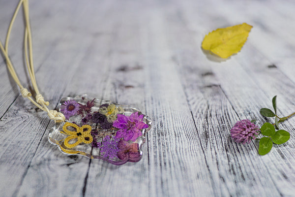 YELLOW BUTTERFLY PENDANT ON PURPLE FLOWERS