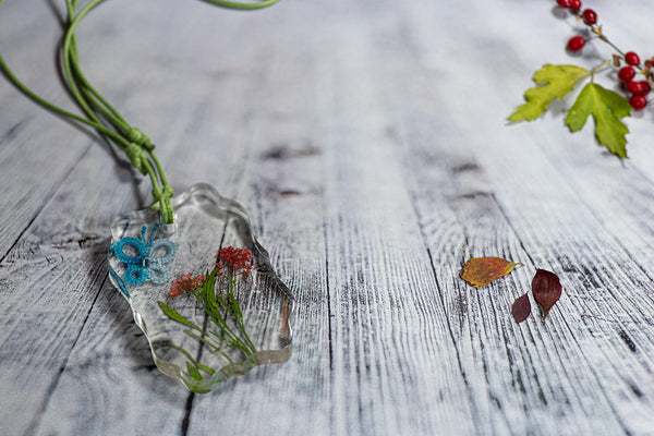 GREEN PENDANT BLUE BUTTERFLY ON THE RED LAWN