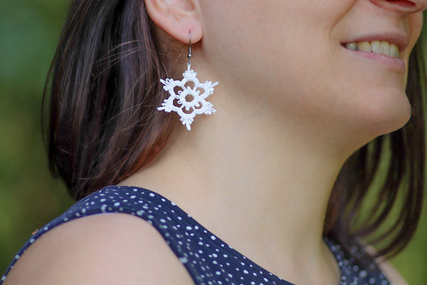 Uhani v obliki bele snežinke, narejene iz čipke z natančnimi detajli s tehniko tatting. Visijo na nastavkih iz nerjavečega jekla.