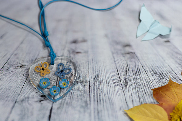 YELLOW AND BLUE BUTTERFLY PENDANT ON FORGET-ME-NOT FLOWERS